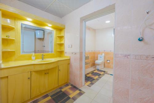 a bathroom with a sink and a shower and a toilet at The Sunshine Farm by Al Dana Paradise Luxury 6BR Secluded Nature Mountains in Khor Fakkan