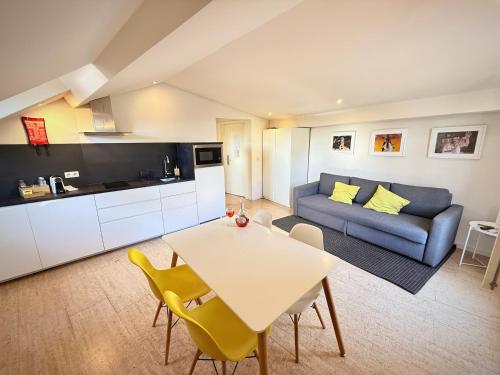a living room with a couch and a table at Ribeira Cinema Apartments in Porto