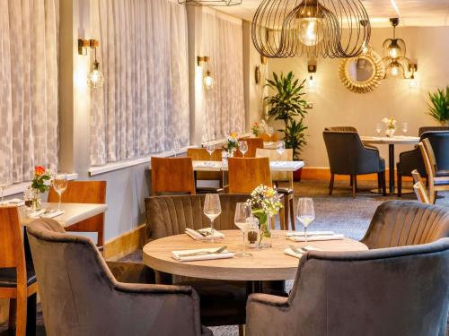 a dining room with a table and chairs at The Harlow Hotel By AccorHotels in Harlow
