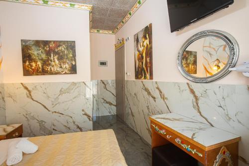 a room with a bed and a mirror on the wall at Studios Nopi-Zoi in Skiathos Town