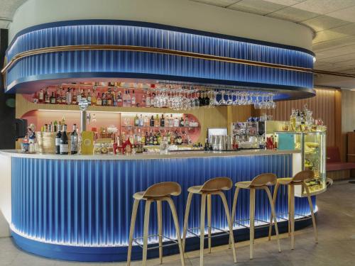 a blue bar with stools in front of it at Ibis Styles Madrid City Las Ventas in Madrid