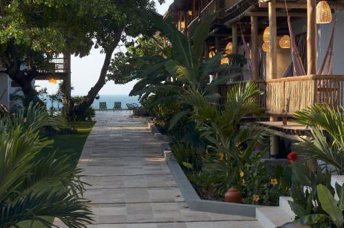 a walkway in front of a building with plants at Pousada Villa Tibá in Jericoacoara