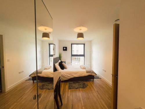 a bedroom with a bed and a mirror at Manchester Waterside Retreat in Manchester