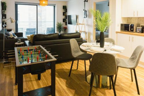 a living room with a chess board on a table at Manchester Waterside Retreat in Manchester