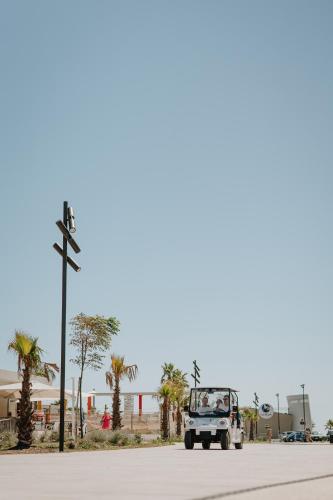 a truck driving down a street with palm trees at Eden Hotel in San Salvo