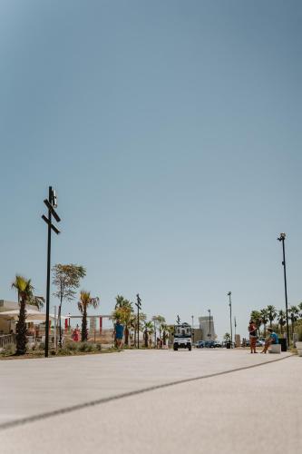 an empty street with palm trees and a truck at Eden Hotel in San Salvo