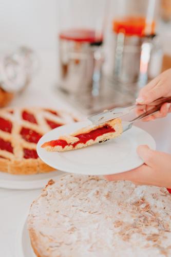 a person holding a slice of pie on a plate at Eden Hotel in San Salvo