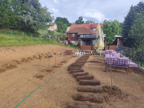 a garden with a path with a table and chairs at Ur Njam-Njam in Vrnjačka Banja