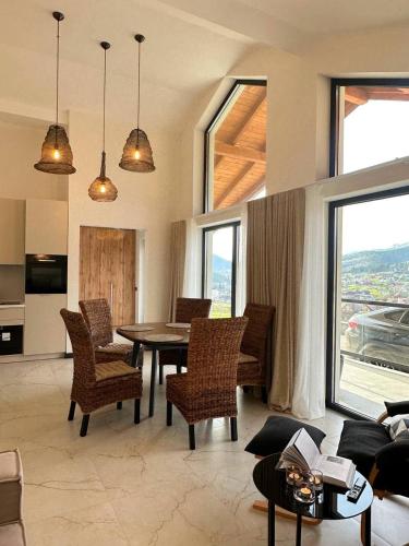 a living room with a table and chairs at EcoBerghaus - Котеджне містечко in Bukovel