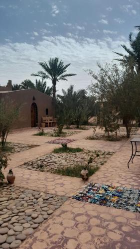 a stone walkway with a pile of trash on the ground at Mhamid Auberge Saharaespace in Mhamid