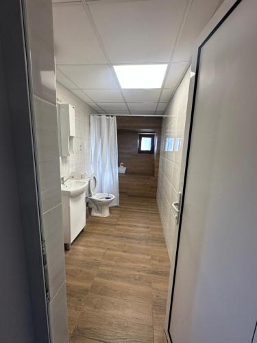 a bathroom with a toilet and a sink at Mountain Whisper Guesthouse in Smolyan