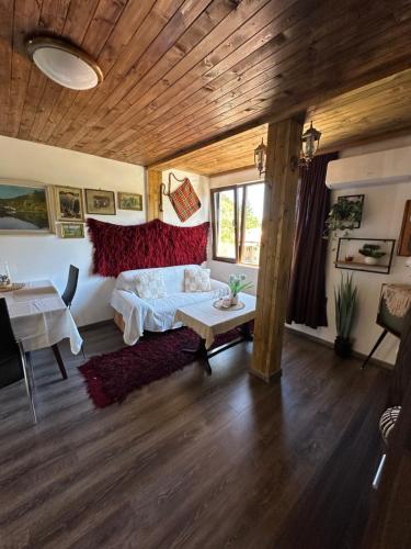 a bedroom with a bed and a table in it at Mountain Whisper Guesthouse in Smolyan