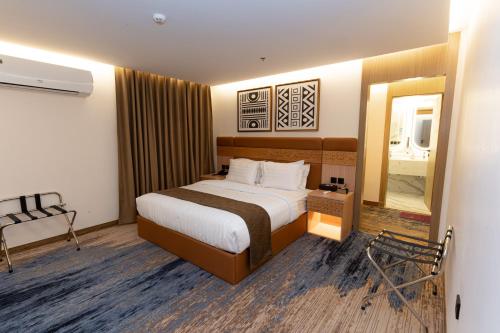 a hotel room with a bed and a mirror at Elite Served Apartments - Hafar Al-Batin - إليت حفر الباطن in Hafr Al Baten
