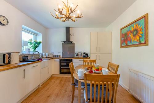 a kitchen with a table and chairs in a kitchen at Bogan in Coldingham