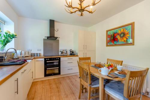 a kitchen with a wooden table and a dining room at Bogan in Coldingham