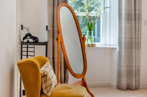 a mirror sitting next to a chair in a room at Bogan in Coldingham
