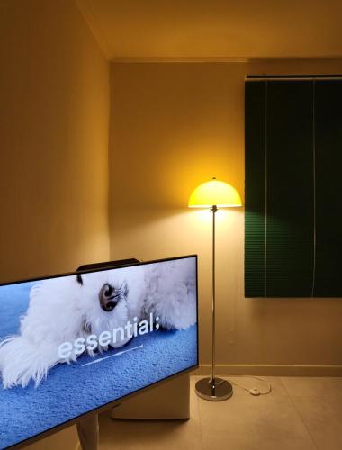a computer monitor sitting next to a lamp at jeonju hotel book and type in Jeonju