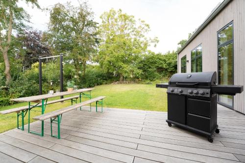 a grill and a picnic table on a patio at Haus am See in Gosdorf