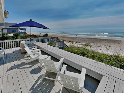 un ponte di legno con sedie e un ombrellone e la spiaggia di Riptide a Sloop Point