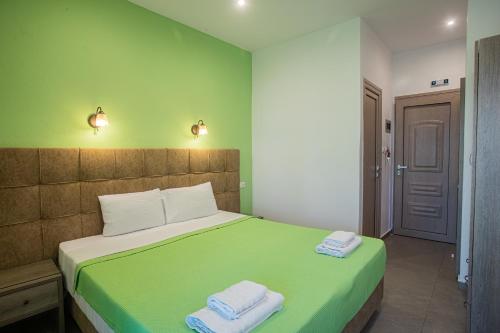 a bedroom with a bed with two towels on it at Studios Nopi-Zoi in Skiathos Town