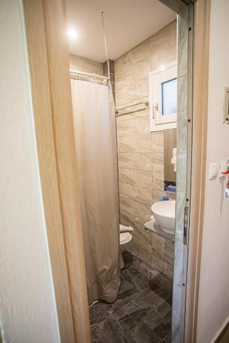 a bathroom with a shower and a toilet at Studios Nopi-Zoi in Skiathos Town