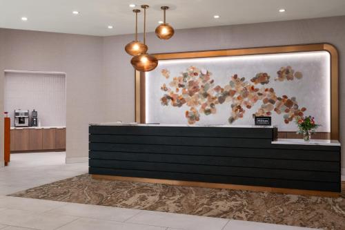 a lobby of a hotel with a painting on the wall at Embassy Suites by Hilton at Hot Springs Convention Center in Hot Springs