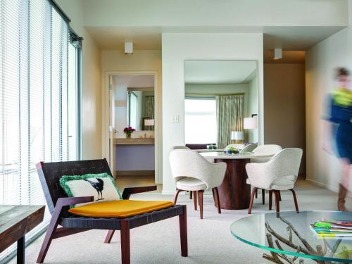 a living room with a couch and chairs and a table at 21c Museum Hotel Bentonville - MGallery in Bentonville