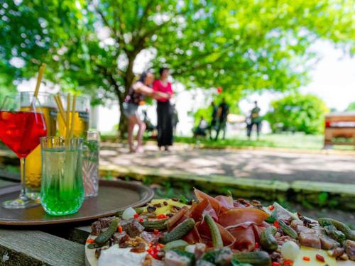 a plate of food with a pizza and a drink at greet Hotel Beaune in Beaune