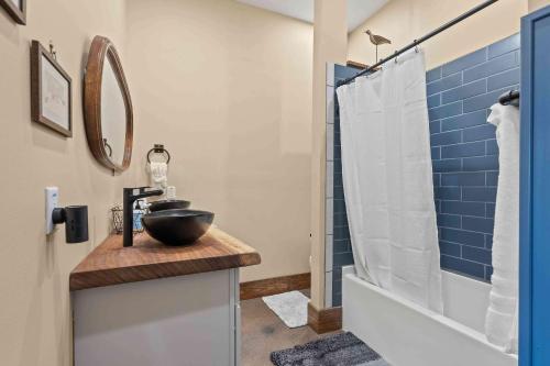 a bathroom with a sink and a shower at Main Street Elevated in Highlands