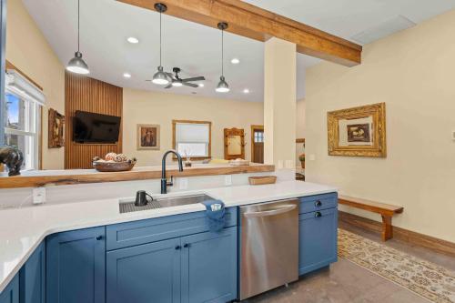 a kitchen with blue cabinets and a sink at Main Street Elevated in Highlands