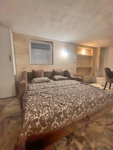 a bedroom with a large bed and a window at Avala Villa With Indoor Pool & Spa in Vrčin