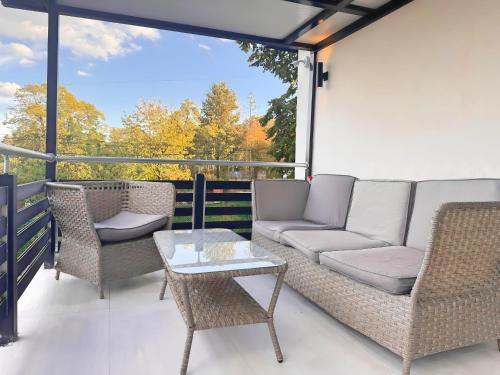a patio with a couch and chairs and a table at Avala Villa With Indoor Pool & Spa in Vrčin