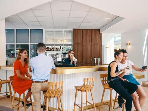 a group of people standing around a bar at Mercure Marseille Canebière Vieux-Port in Marseille