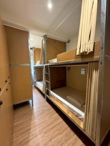 a small room with bunk beds in it at KM Hostel in Chiayi City