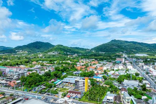 an aerial view of a city with mountains in the background at Phuket Five For tune Holiday Hotel in Phuket Town