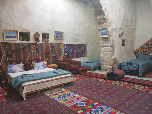 a bedroom with a bed and a couch in a room at Mumia heritage restaurant & house in Kerak