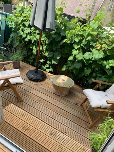 a wooden deck with a lamp and chairs on it at Auszeit Deluxe in Kirchheim unter Teck