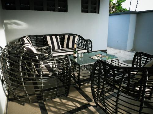 a patio with a table and chairs and a couch at LV-21 Service Apartment MO4a in Lagos