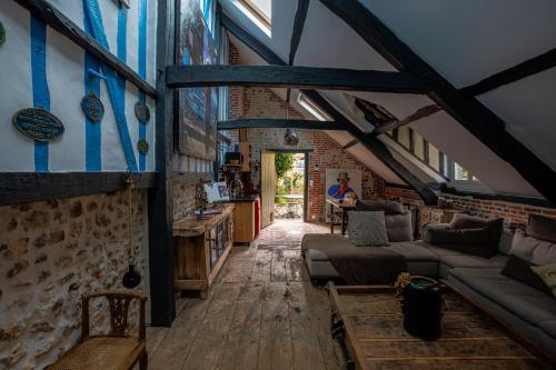 a living room with a couch and a table at La Petite Maison in Honfleur