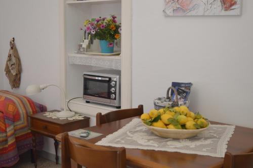 a room with a table with a bowl of fruit on it at Villa Irene Pisticci-Matera in Pisticci