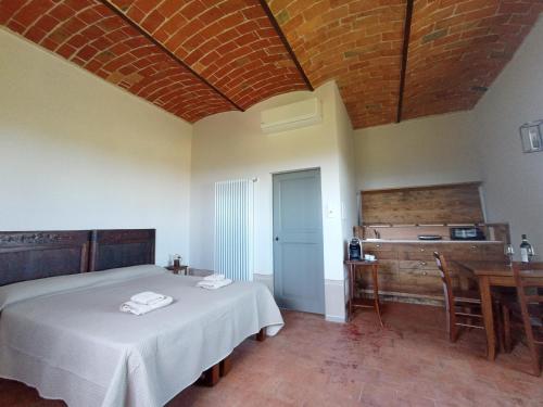 a bedroom with a bed and a desk and a sink at Cascina La Serra in Vaglio Serra