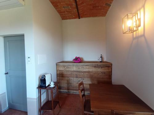 a dining room with a wooden table and a wooden chest at Cascina La Serra in Vaglio Serra