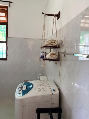 a washing machine sitting in a room next to a wall at Metro Stay in Kurunegala