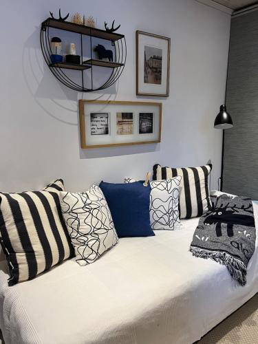 a white couch with pillows in a living room at Casa Hylle in Löddeköpinge
