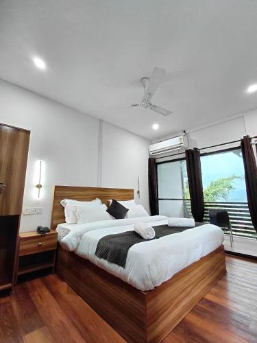 a bedroom with a large bed and a window at Ryka Tranquil Resort in Guwahati