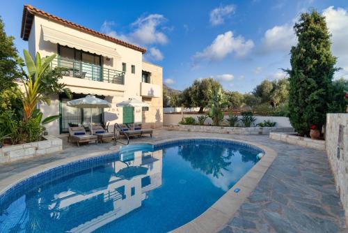 a swimming pool in front of a villa at Villa Dafni with Private Pool in Gouves
