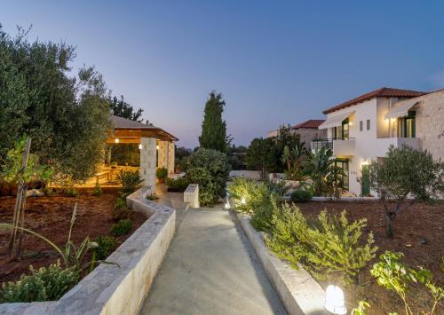 a garden with a walkway in front of a house at Villa Dafni with Private Pool in Gouves