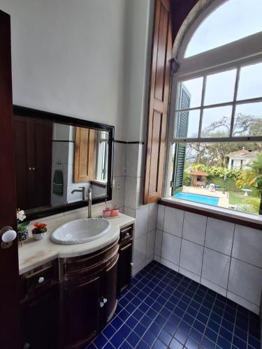 a bathroom with a sink and a window at Casa Aprazível 5 in Rio de Janeiro