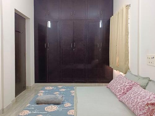 a room with black cabinets and a rug on the floor at Indira Residence 5bhk villa in Jāmb