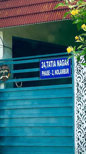 a blue building with a sign on the side of it at Indira Residence 5bhk villa in Jāmb